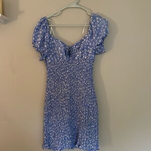 blue floral mini dress with tie at the chest and puffy sleeves